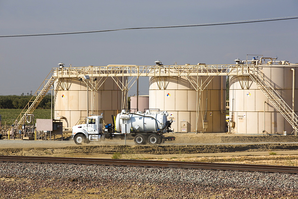 A fracking site being fracked near Wasco in California's Central Valley, USA. Fracking for natural gas and oil, has reduced energy prices in the US, but fracking is a water hungry industry, that competes directly with the agricultural sector for water. After a 4 year long drought water is running out.  Fracking also contaminates ground water supplies from all the chemicals that are pumped underground to frack the fossil fuel bearing rocks.