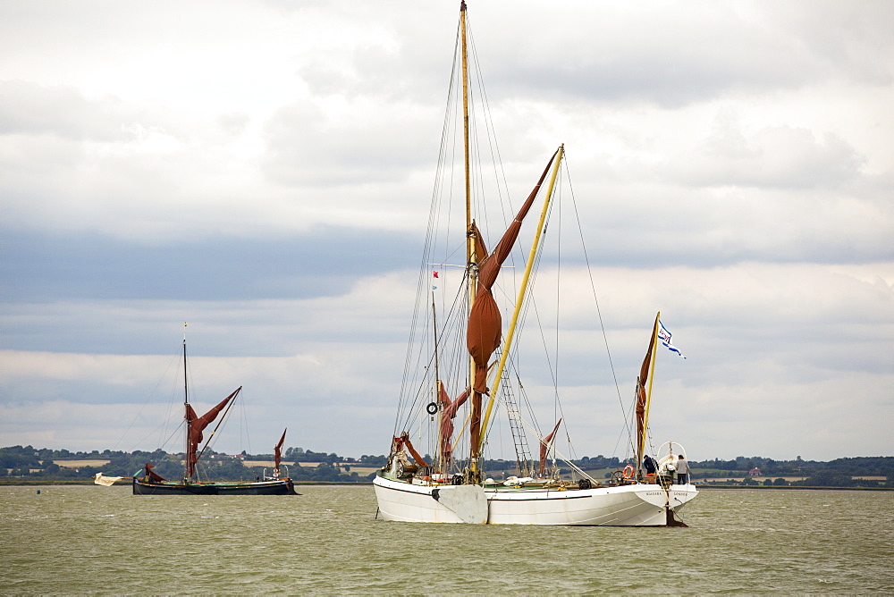 Traditional wooden Smack fishing boats off Brightlingsea, Essex, UK.