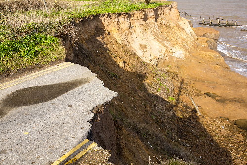 A road eroded and dropping off into the North sea at Happisburgh, Norfolk, a rapidly eroding section of coastline, UK.