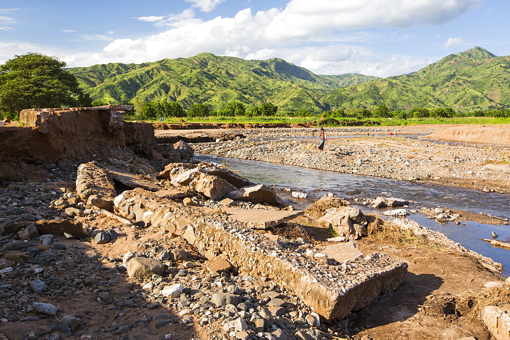 In mid January 2015, a three day period of excessive rain brought unprecedented floods to the small poor African country of Malawi. It displaced nearly quarter of a million people, devastated 64,000 hectares of land, and killed several hundred people. This shot shows a road bridge destroyed near Chikwawa.