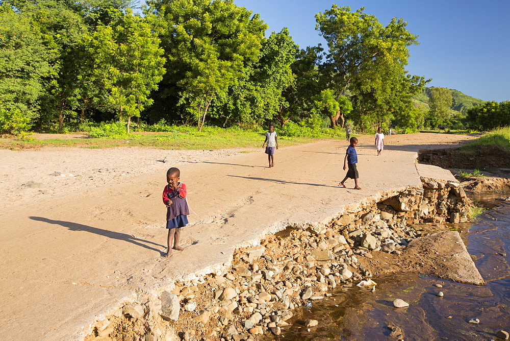 In mid January 2015, a three day period of excessive rain brought unprecedented floods to the small poor African country of Malawi. It displaced nearly quarter of a million people, devastated 64,000 hectares of land, and killed several hundred people. This shot shows a road and bridge washed away near Chikwawa.