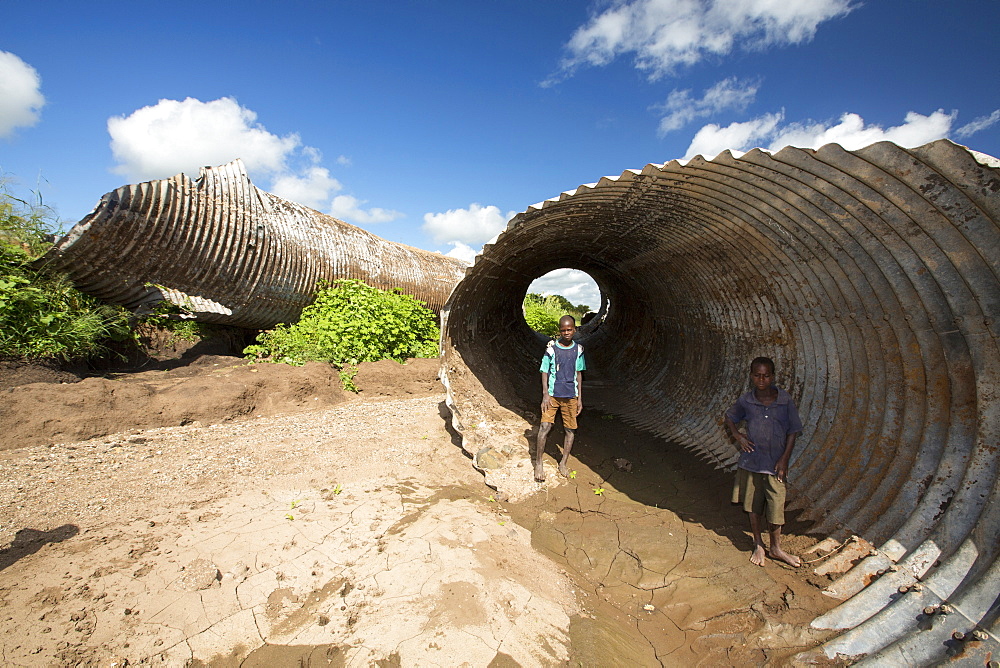 In mid January 2015, a three day period of excessive rain brought unprecedented floods to the small poor African country of Malawi. It displaced nearly quarter of a million people, devastated 64,000 hectares of land, and killed several hundred people. This shot shows a drainage pipe that was washed away near Chikwawa.