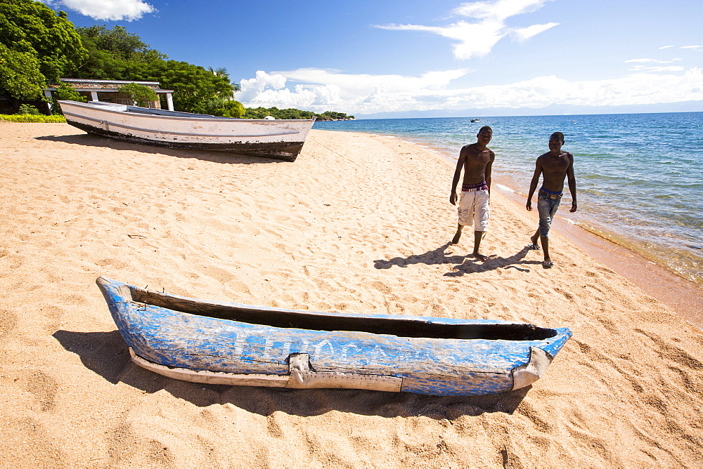 A traditional dug out canoe on a beach at Cape Maclear on the shores of Lake Malawi, Malawi, Africa.