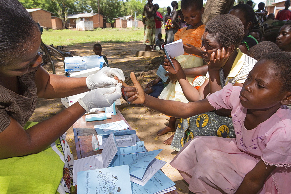 January 2015 saw a three day period of excessive rain which brought unprecedented floods to the small poor African country of Malawi. It displaced nearly quarter of a million people, devastated 64,000 hectares of land, and killed several hundred people. This shot shows A Medicin Sans Frontieres clinic in Makhanga testing local people, many of whom now have malaria, as a result of the drying up flood waters providing ideal breeding grounds for mosquitoes.