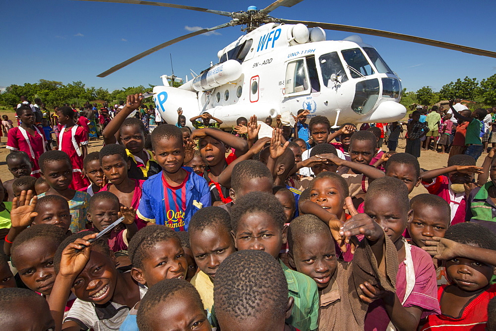 In mid January 2015, a three day period of excessive rain brought unprecedented floods to the small poor African country of Malawi. It displaced nearly quarter of a million people, devastated 64,000 hectares of land, and killed several hundred people. This shot shows A Russian Mi8 helicopter being used by the United Nations, World Food Program to deliver food aid to areas still cut off by the flooding, around Bangula and Mkhanga.