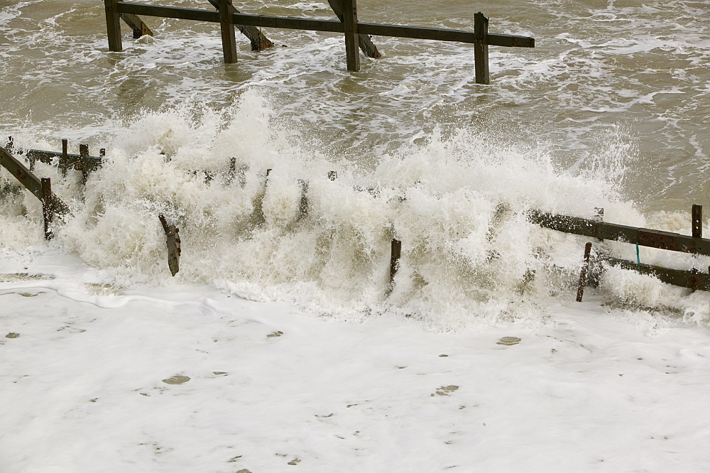 Waves crashing against sea defences at Happisburgh on the fastest eroding section of the UK coast, Norfolk, England, United Kingdom, Europe