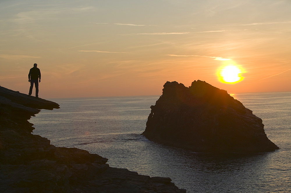 A man on the cliff tops at Boscastle overlooking Meachard Island, Cornwall, England, United Kingdom, Europe