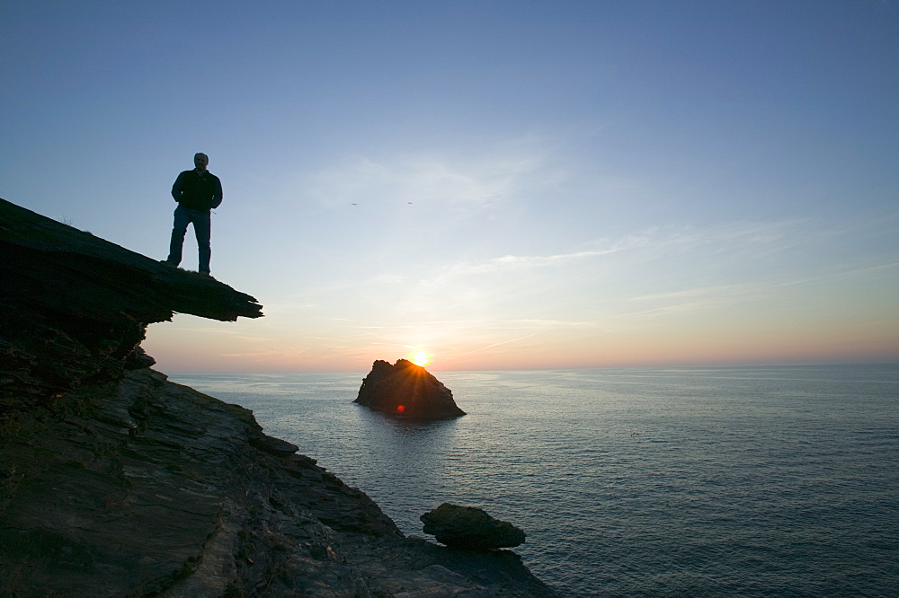 A man on the cliff tops at Boscastle overlooking Meachard Island, Cornwall, England, United Kingdom, Europe