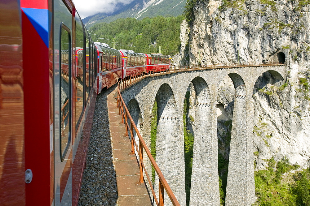 The Bernina Glacier express that goes from Chur in Switzerland to Tirano in Italy, crossing the famous Landwasser viaduct, Graubunden, Switzerland, Europe