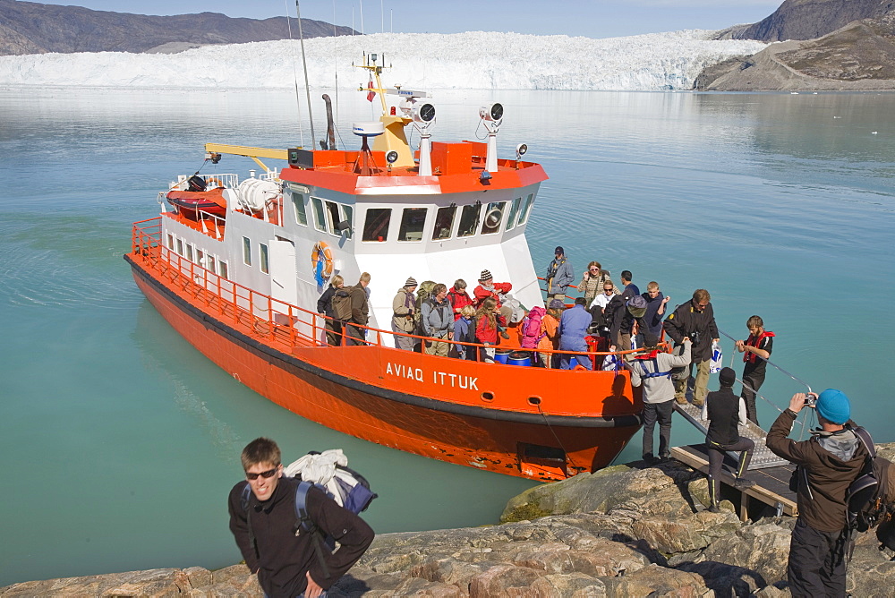 Passengers landing at Camp Victor by the Eqip Sermia glacier that is receding rapidly due to global warming on the west coast of Greenland, Polar Regions