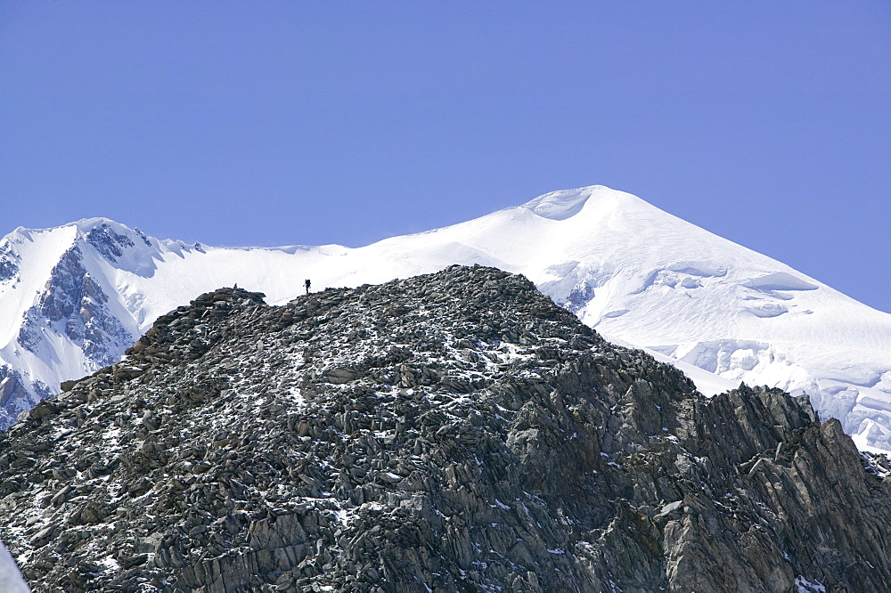 A climber in front of Mont Blanc above Chamonix, Haute Savoie, France, Europe