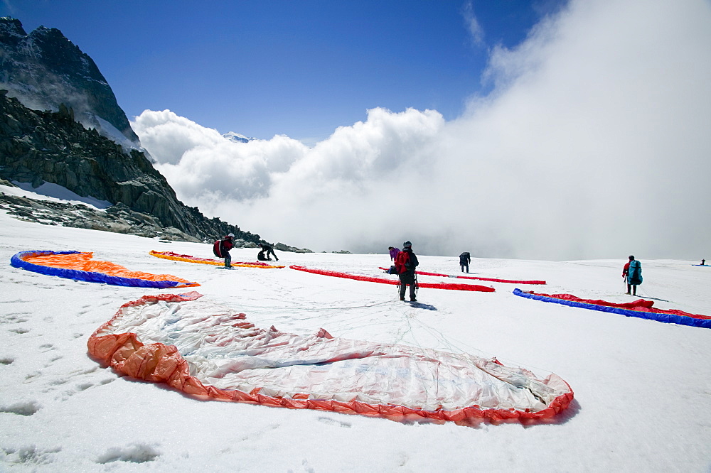 Paraponters preparing to take off from the Grand Montets above Chamonix, Haute Savoie, France, Europe