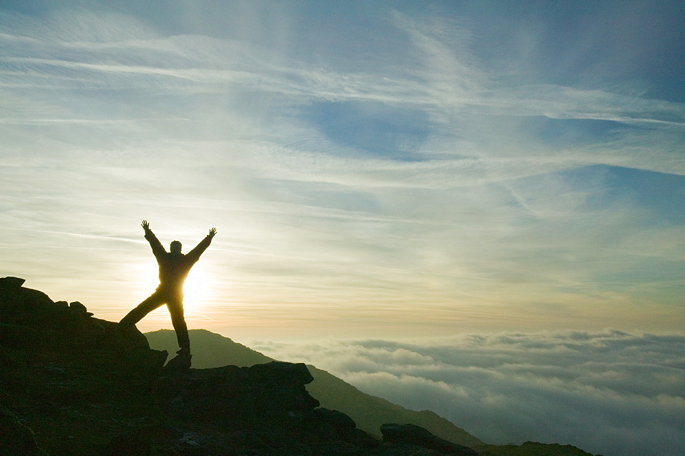 A walker above the clouds on Wet Side Edge in the Lake District National Park, Cumbria, England, United Kingdom, Europe