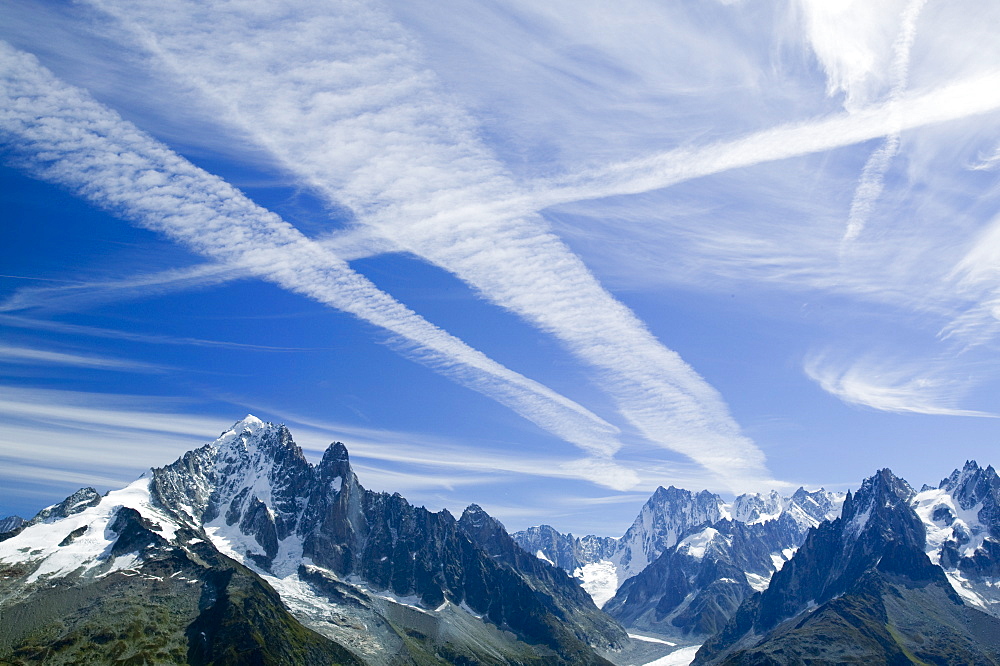 Airplane vapour trails over the Mer du Glace, Chamonix, Haute Savoie, France, Europe