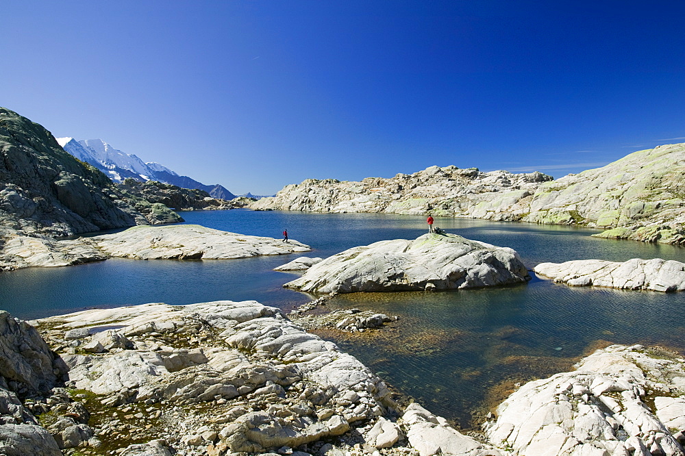 Walkers at Lac Noir in the Aiguille Rouge National Park near Chamonix, Haute Savoie, France, Europe