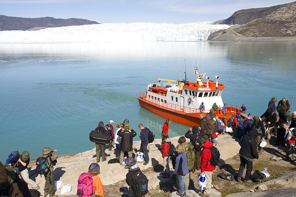 Passengers landing at Camp Victor by the Eqip Sermia glacier that is receding rapidly due to global warming on the west coast of Greenland, Polar Regions