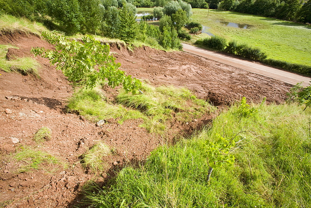 A landslide caused by torrential rain waterlogging the ground which blocked a road for a week in Shropshire, England, United Kingdom, Europe