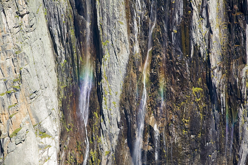 Waterfalls cascading down newly exposed rock where the Argentiere glacier has melted back due to global warming, Chamonix, Haute Savoie, France, Europe