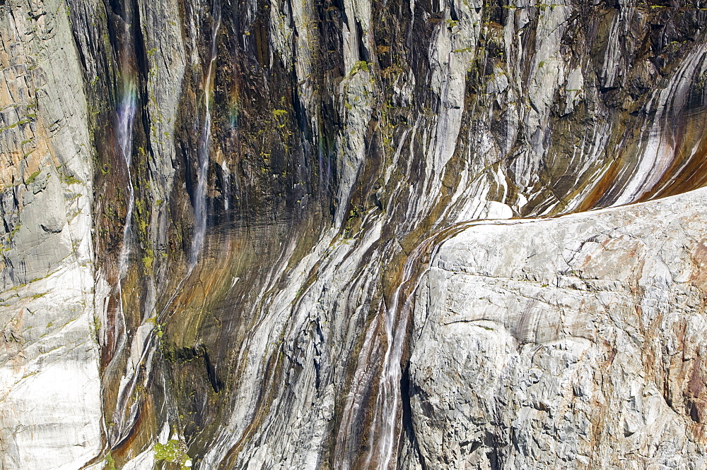 Waterfalls cascading down newly exposed rock where the Argentiere glacier has melted back due to global warming, Chamonix, Haute Savoie, France, Europe