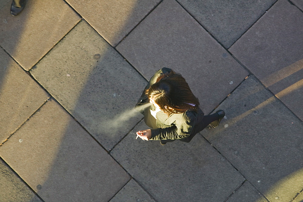 A woman smoking in public, Leicester, Leicestershire, England, United Kingdom, Europe