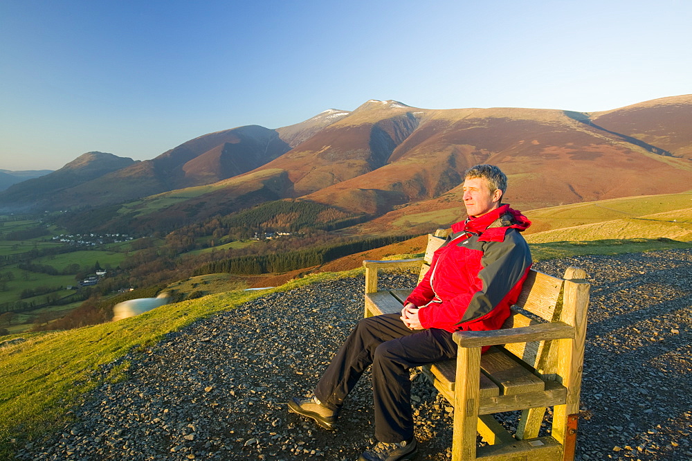 A man enjoying the view from Latrigg above Keswick, Lake District National Park, Cumbria, England, United Kingdom, Europe