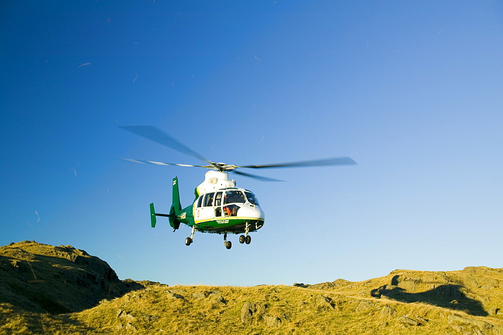 An air ambulance attending a mountain rescue in the Lake District, Cumbria, England, United Kingdom, Europe