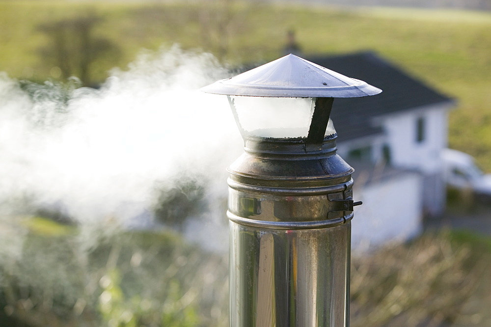 Smoke from a house chimney, Cumbria, England, United Kingdom, Europe