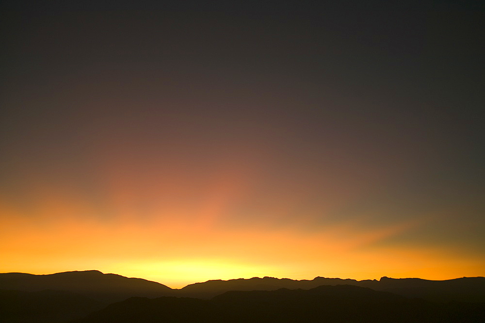 Afterglow light long after sunset reflected over the Lake District hills during an extreme high pressure, Lake District, Cumbria, England, United Kingdom, Europe