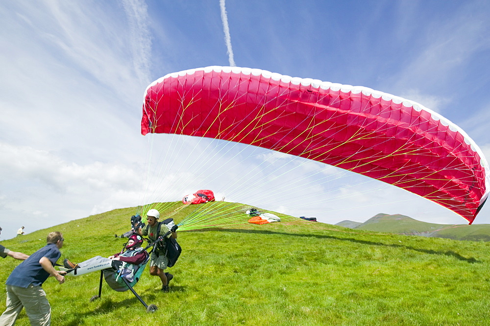 A wheelchair bound disabled person preparing to go parapont flying above Keswick, Lake District, Cumbria, England, United Kingdom, Europe