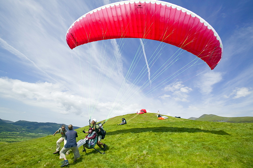 A wheelchair bound disabled person preparing to go parapont flying above Keswick, Lake District, Cumbria, England, United Kingdom, Europe