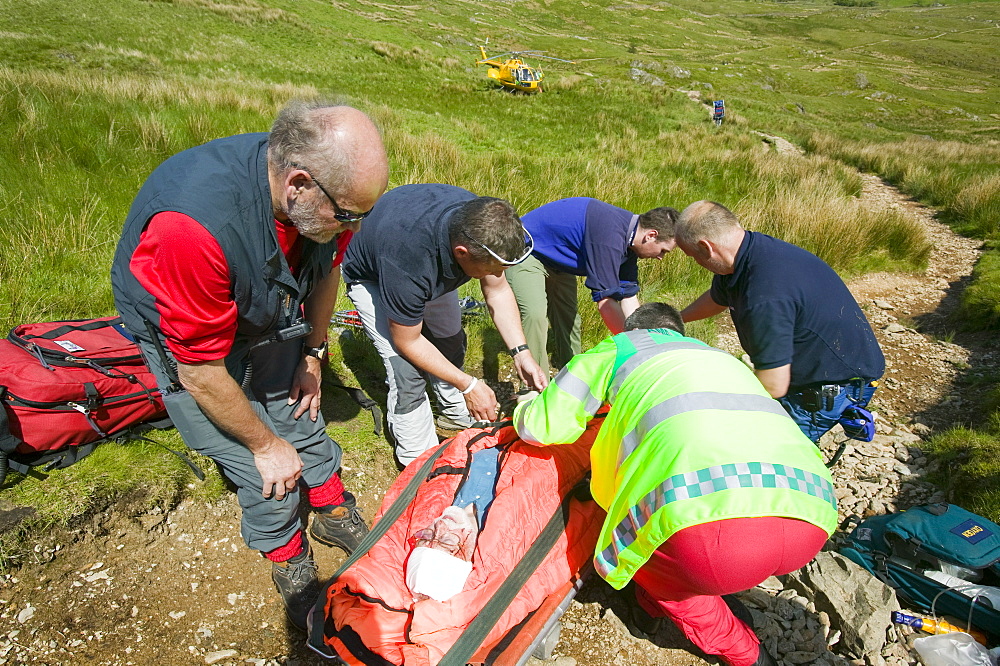 An air ambulance attends a mountain rescue on Wansfell, Lake District, Cumbria, England, United Kingdom, Europe