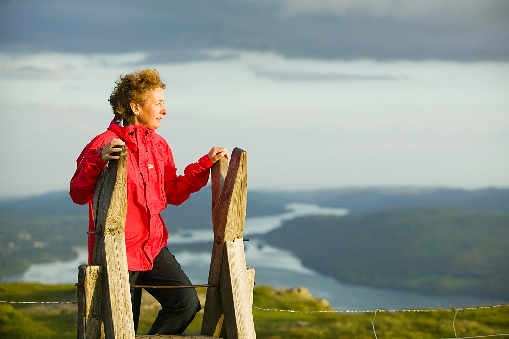 A woman on the summit ridge of Wansfell above Ambleside, Lake District, Cumbria, England, United Kingdom, Europe