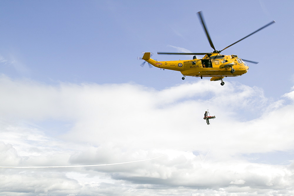 An injured climber with a dislocated shoulder is winched off Pavey Ark by the Langdale Ambleside Mountain Rescue Team and RAF Sea King helicopter, Lake District, Cumbria, England, United Kingdom, Europe