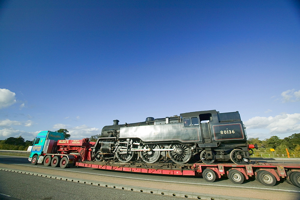 A steam train being transported on a low loader, Leicestershire, England, United Kingdom, Europe