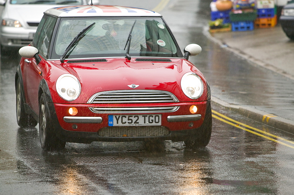 A car driving in the rain in Ambleside, Lake District, Cumbria, England, United Kingdom, Europe