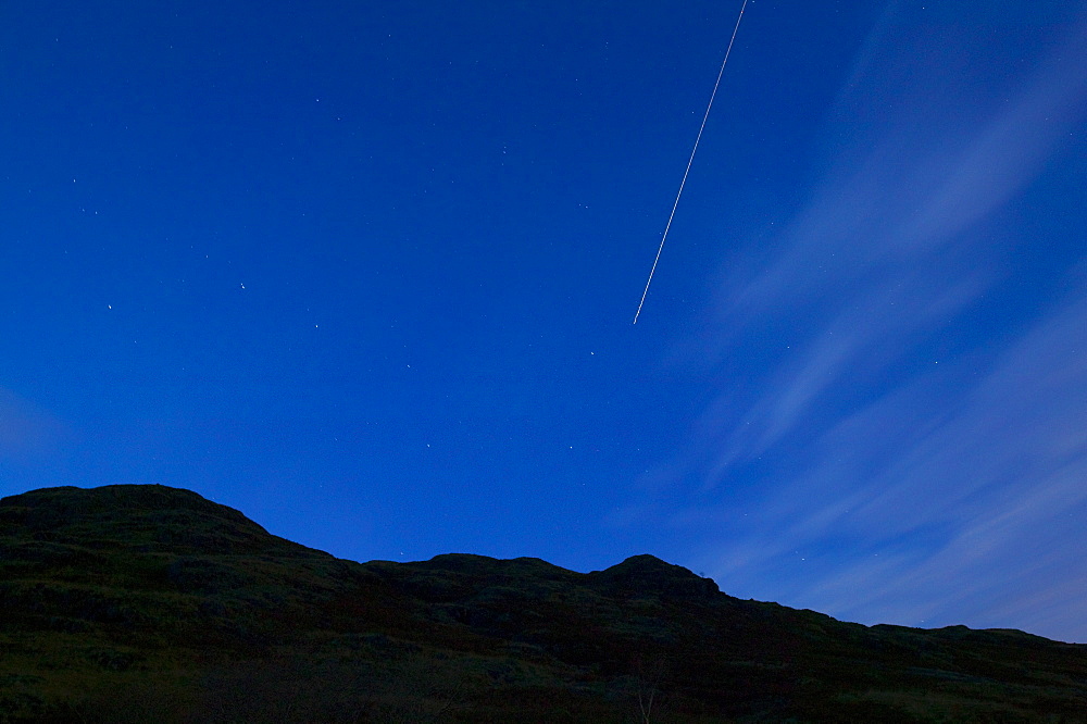 The constellation of the Plough and stars at night with a jet plane flying through, Lake District, Cumbria, England, United Kingdom, Europe