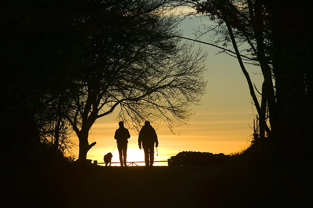 Walkers on a country lane near Troutbeck, Lake District, Cumbria, England, United Kingdom, Europe