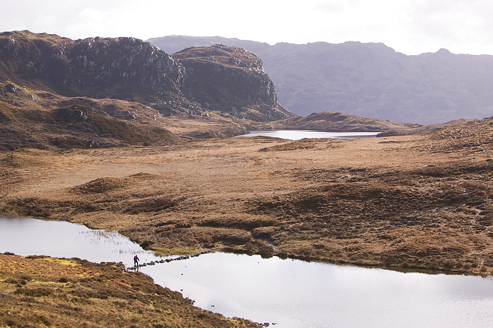 Stepping stones across a loch between Loch Nevis and Loch Morar, Highlands, Scotland, United Kingdom, Europe