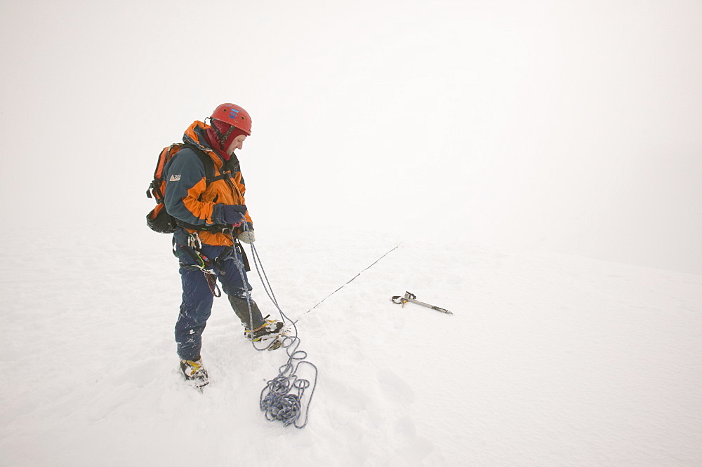 A winter climber on Aonach Mhor, Grampians, Highlands, in Scotland, United Kingdom, Europe