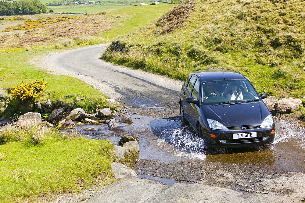 A car crossing a ford in the Lake District near Hesket Newmarket, Cumbria, England, United Kingdom, Europe