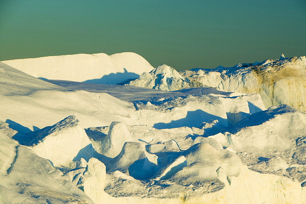 Midnight sun on icebergs from the Jacobshavn Glacier (Sermeq Kujalleq), Greenland, Polar Regions