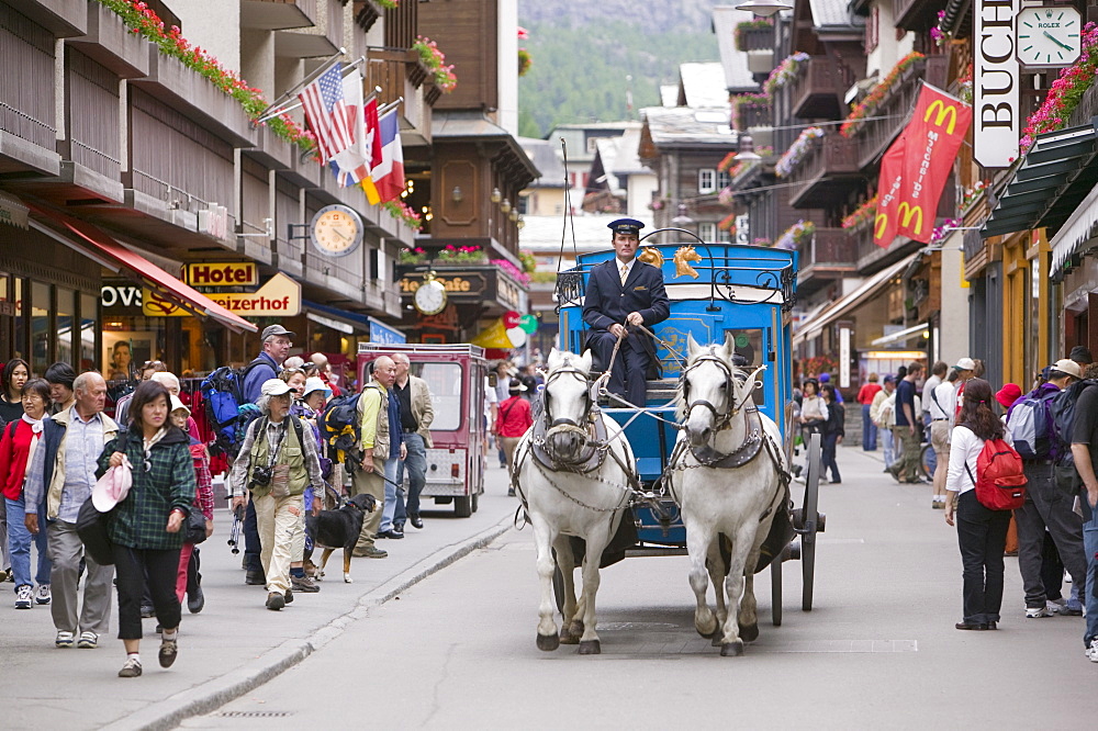 A coach and horses in the main street, Zermatt, Switzerland, Europe