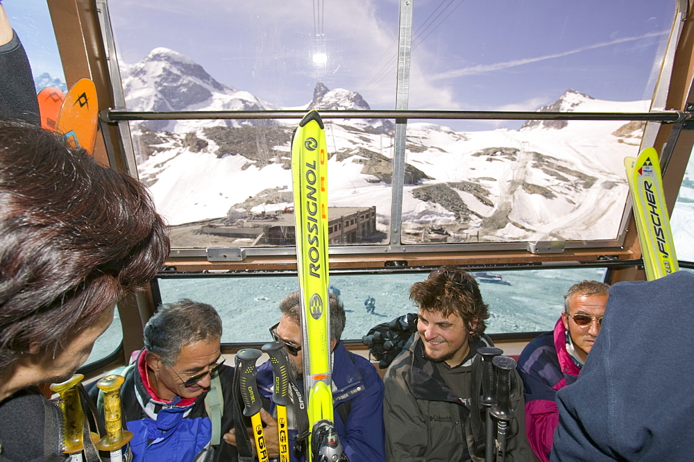 Summer skiers in the Klein Matterhorn cablecar above Zermatt, Switzerland, Europe