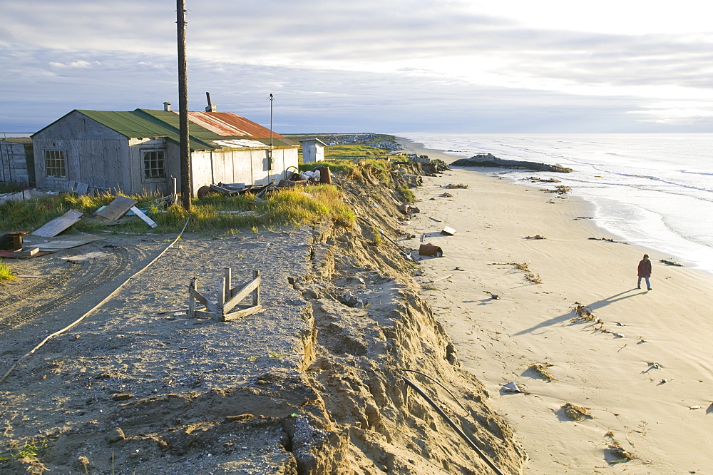 J J Weyouanna's wife stands on the beach where their house used to be on Shishmaref, a tiny island inhabited by around 600 Inuits, between Alaska and Siberia in the Chukchi Sea, United States of America, North America