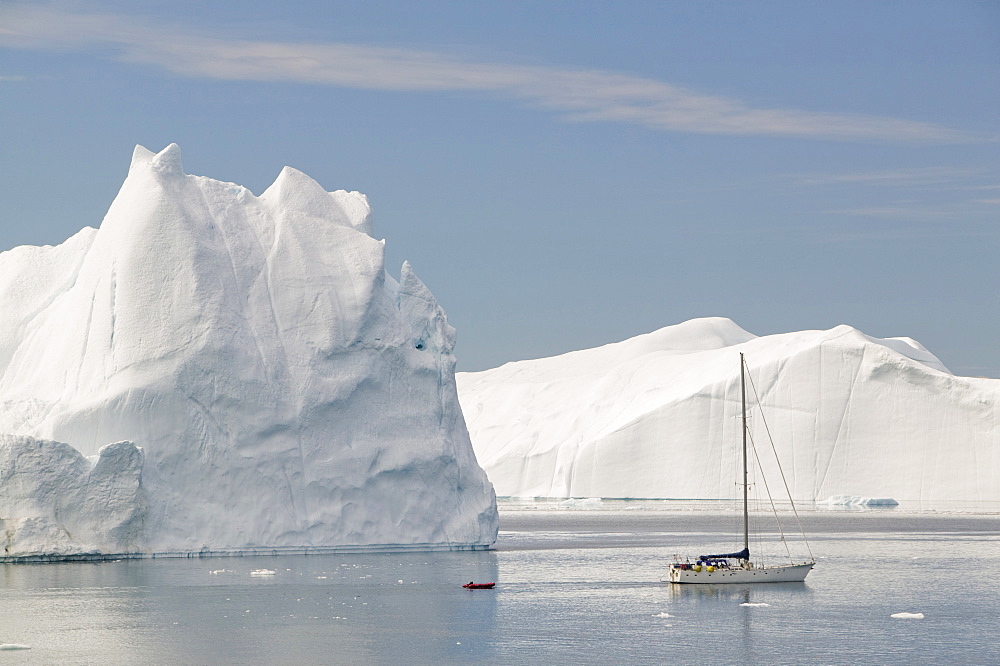 A French film crew documenting the effects of climate change sails their boat through icebergs from the Jacobshavn glacier (Sermeq Kujalleq), Greenland, Polar Regions