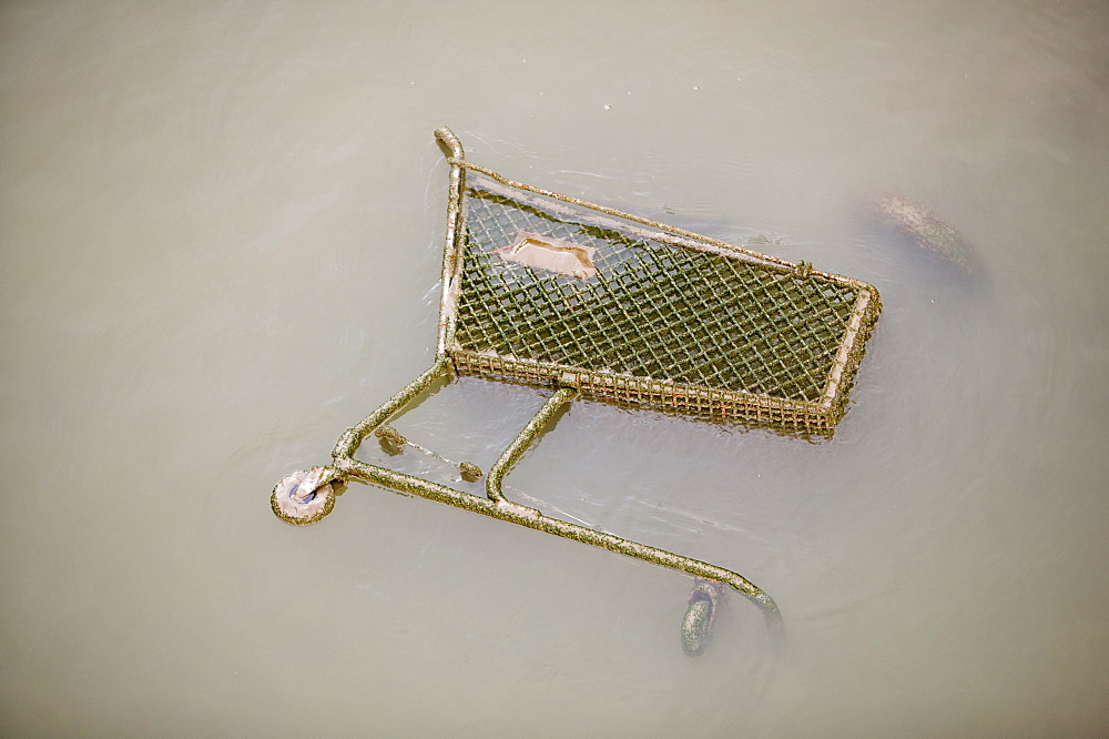 Shopping trolley dumped in the docks in Liverpool, Merseyside, England, United Kingdom, Europe