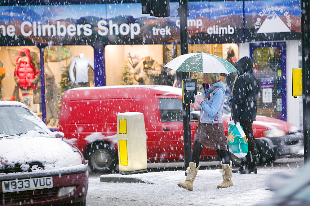 Shoppers trudging through snow in Ambleside, Cumbria, England, United Kingdom, Europe