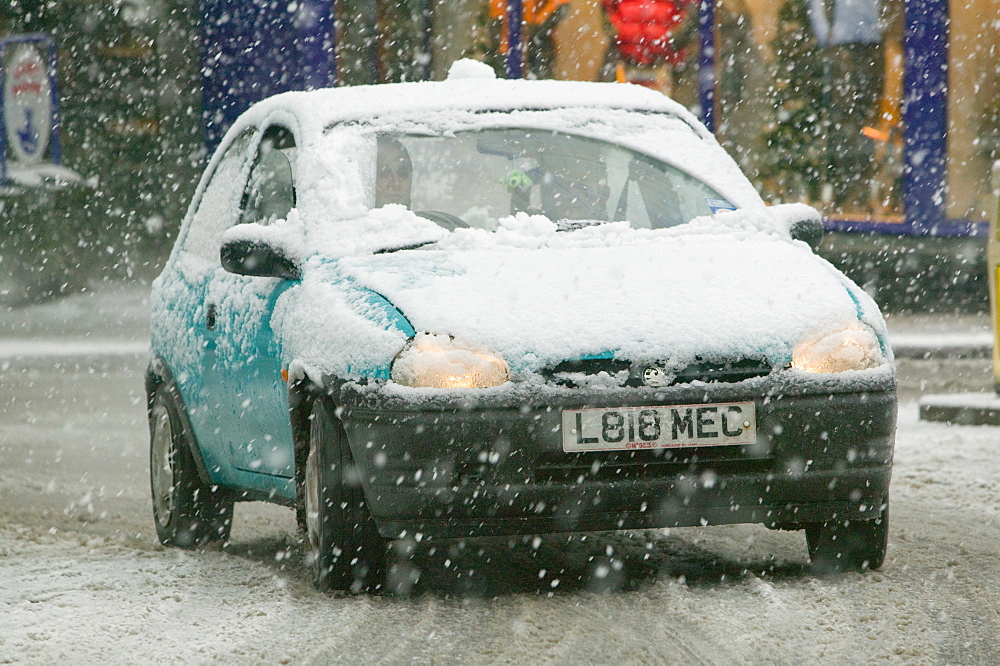 A car in the snow in Ambleside, Cumbria, England, United Kingdom, Europe