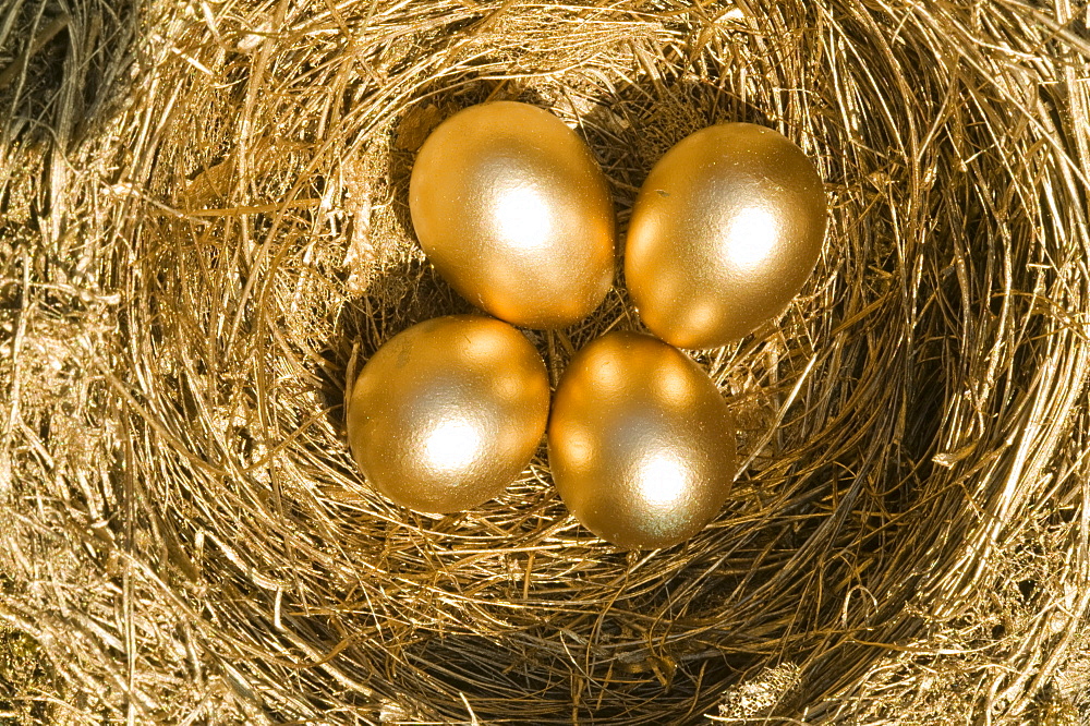 Four golden eggs in a nest 