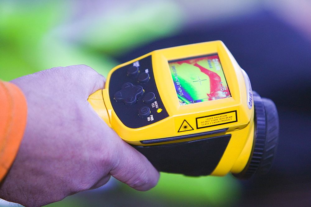 A man uses a thermal imaging camera to test how dried out a Carlisle house is after the floods, Cumbria, England, United Kingdom, Europe